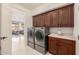 Laundry room with washer, dryer, and wooden cabinets at 2128 E Leo Pl, Chandler, AZ 85249