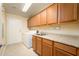 Bright laundry room with ample cabinet space, washer, dryer, and utility sink at 21320 N 56Th St # 1175, Phoenix, AZ 85054