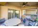 Outdoor patio with table and chairs, ceiling fan and sliding glass door access at 21320 N 56Th St # 1175, Phoenix, AZ 85054