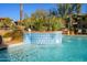 Refreshing community pool with tiled waterfall feature and landscaping at 21320 N 56Th St # 1175, Phoenix, AZ 85054