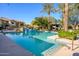 Community pool with a waterfall feature and plenty of lounge chairs at 21320 N 56Th St # 1175, Phoenix, AZ 85054