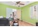 Green bedroom with a ceiling fan, desk and an American Flag at 2172 W Pinkley Ave, Coolidge, AZ 85128