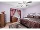 Comfortable bedroom featuring carpet, ceiling fan and a large window at 2172 W Pinkley Ave, Coolidge, AZ 85128