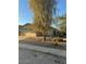 House with a large tree in the front yard and gravel landscaping at 2172 W Pinkley Ave, Coolidge, AZ 85128