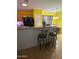 Kitchen with breakfast bar, black appliances, and yellow walls at 2172 W Pinkley Ave, Coolidge, AZ 85128