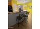 Kitchen with breakfast bar and yellow walls at 2172 W Pinkley Ave, Coolidge, AZ 85128