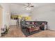 Open-concept living room featuring tile flooring, neutral walls, and a large sectional sofa, creating a comfortable living space at 2172 W Pinkley Ave, Coolidge, AZ 85128