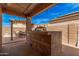 Outdoor kitchen with a built-in grill and dining area, perfect for outdoor entertainment and summer barbecues at 2172 W Pinkley Ave, Coolidge, AZ 85128