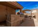 Spacious outdoor kitchen featuring a built-in grill, perfect for outdoor gatherings and culinary adventures at 2172 W Pinkley Ave, Coolidge, AZ 85128