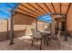 Cozy backyard patio with a shaded pergola, dining table, and chairs, creating a perfect space for outdoor dining at 2172 W Pinkley Ave, Coolidge, AZ 85128