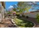 Landscaped backyard with putting green and a waterfall feature at 2181 W Thompson Pl, Chandler, AZ 85286