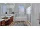 Elegant bathroom with soaking tub, double vanity, and glass shower at 2181 W Thompson Pl, Chandler, AZ 85286