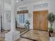 Bright and airy entryway with tile flooring and a sitting bench at 2181 W Thompson Pl, Chandler, AZ 85286