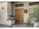 Elegant double doors with a decorative wreath and potted plants at 2181 W Thompson Pl, Chandler, AZ 85286