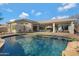 Inviting kidney shaped pool with a large backyard and patio at 2181 W Thompson Pl, Chandler, AZ 85286