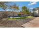 Relaxing pool with waterfall feature and grassy area at 2181 W Thompson Pl, Chandler, AZ 85286