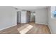 Bedroom with barn door to en-suite bathroom and hardwood floors at 225 N Standage -- # 77, Mesa, AZ 85201