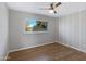 Bright bedroom with wood-look floors and ceiling fan at 225 N Standage -- # 77, Mesa, AZ 85201