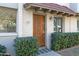 Ornate wood front door with colorful welcome mat at 225 N Standage -- # 77, Mesa, AZ 85201