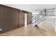 Living room with barn door, wood-look floors, and modern staircase at 225 N Standage -- # 77, Mesa, AZ 85201