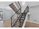 Modern staircase with dark metal railing and carpeted steps at 225 N Standage -- # 77, Mesa, AZ 85201