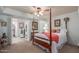 Cozy bedroom with a wooden four-poster bed and ensuite bathroom access at 2256 W Lindner Ave # 25, Mesa, AZ 85202