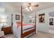 Spacious bedroom with a wooden four-poster bed and adjacent bathroom access at 2256 W Lindner Ave # 25, Mesa, AZ 85202