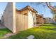 Side view of the house showcasing stucco exterior and wooden fence at 2256 W Lindner Ave # 25, Mesa, AZ 85202