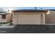 Attached garage with light beige door and exterior light at 2256 W Lindner Ave # 25, Mesa, AZ 85202