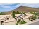 Aerial view showing a two-story house with solar panels and a mountain backdrop at 23046 N 21St St, Phoenix, AZ 85024