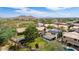 Aerial view of house with pool and solar panels, in a mountain setting at 23046 N 21St St, Phoenix, AZ 85024