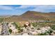 Aerial view of a house nestled in a quiet desert neighborhood near mountains at 23046 N 21St St, Phoenix, AZ 85024