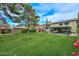 Spacious backyard featuring a large manicured lawn and covered patio at 23046 N 21St St, Phoenix, AZ 85024