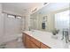 Bright bathroom with a large vanity, modern fixtures, and a shower-tub combination at 23046 N 21St St, Phoenix, AZ 85024