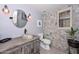 Modern powder room with tiled walls, a unique vessel sink, and stylish lighting fixtures at 23046 N 21St St, Phoenix, AZ 85024