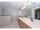 Elegant bathroom featuring double sinks, ample counter space, and walk-in shower at 23046 N 21St St, Phoenix, AZ 85024