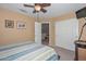 Well-lit bedroom featuring closet, ceiling fan, and ensuite bathroom at 23046 N 21St St, Phoenix, AZ 85024