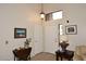 Inviting entryway with light flooring, featuring a coat closet and a view to the living room at 23046 N 21St St, Phoenix, AZ 85024