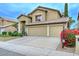 View of front yard, two-story home featuring a well-manicured front yard and a spacious three-car garage at 23046 N 21St St, Phoenix, AZ 85024