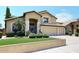 Two-story house with three-car garage, landscaped front yard, and a teal door at 23046 N 21St St, Phoenix, AZ 85024