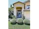 Landscaped front yard with artificial turf and three bushes at 23046 N 21St St, Phoenix, AZ 85024