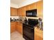 Modern kitchen with granite countertops and black appliances at 23046 N 21St St, Phoenix, AZ 85024