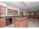 Kitchen with wooden cabinets, black appliances, and a view into the dining area at 23046 N 21St St, Phoenix, AZ 85024