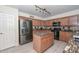 Well-lit kitchen offering stainless steel refrigerator, kitchen island, and ample cabinet space at 23046 N 21St St, Phoenix, AZ 85024