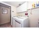 Laundry room with a modern washer and dryer set and ample cabinet space at 23046 N 21St St, Phoenix, AZ 85024