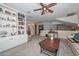 Upstairs loft featuring built-in bookcase, ceiling fan, and adjacent bathroom and bedroom at 23046 N 21St St, Phoenix, AZ 85024