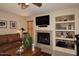 Living area with a fireplace and built-in shelving units at 23046 N 21St St, Phoenix, AZ 85024