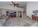 Bright living room featuring a cozy sofa, entertainment center, and stairs, with natural light streaming in at 23046 N 21St St, Phoenix, AZ 85024