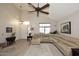 Spacious living room with vaulted ceilings, featuring a large sectional sofa and area rug at 23046 N 21St St, Phoenix, AZ 85024