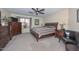 Carpeted main bedroom featuring a ceiling fan, dresser, and lots of natural light at 23046 N 21St St, Phoenix, AZ 85024